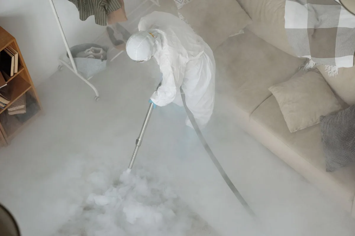 Biohazard cleanup technician in protective equipment, Lyons, WI